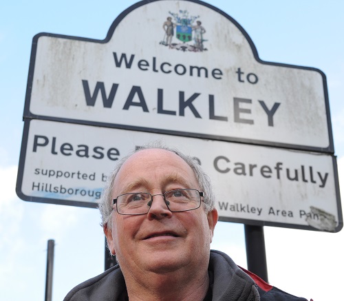 Bernard Little in front of a Welcome to Walkley sign