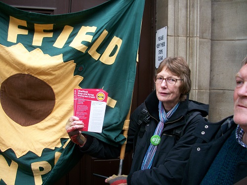 Green Party activists with banner outside DWP offices