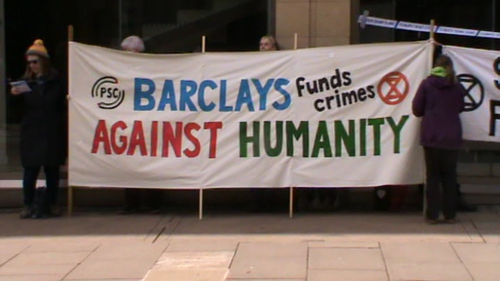 Banner reading "Barclays funds crimes against humanity."