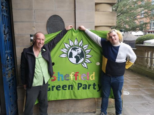 Cllr Douglas Johnson and Dylan Lewis-Creser holding the Green Party banner