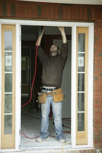 A workman making repairs to a house