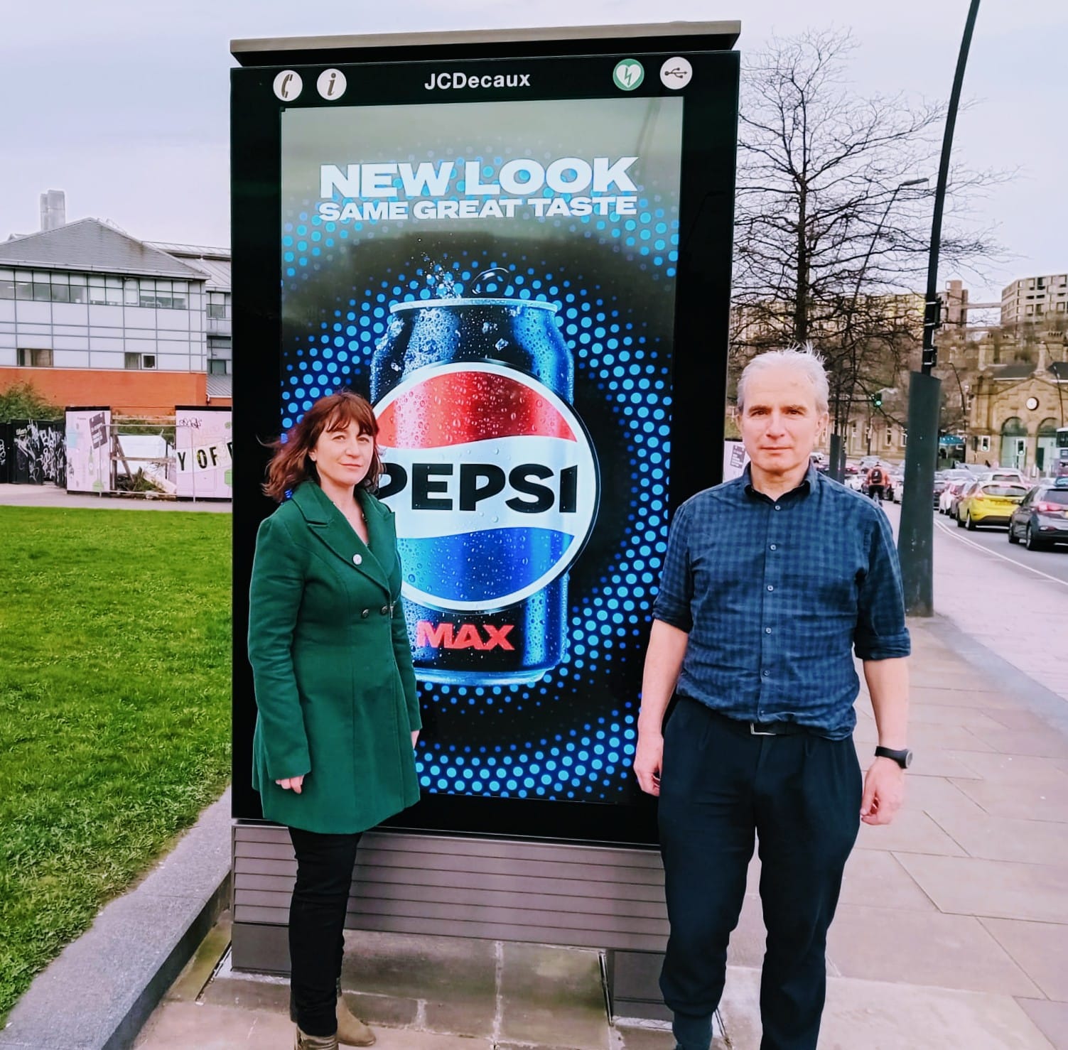 Councillors Marieanne Elliot and Toby Mallinson in front of a digital billboard sited in the pavement