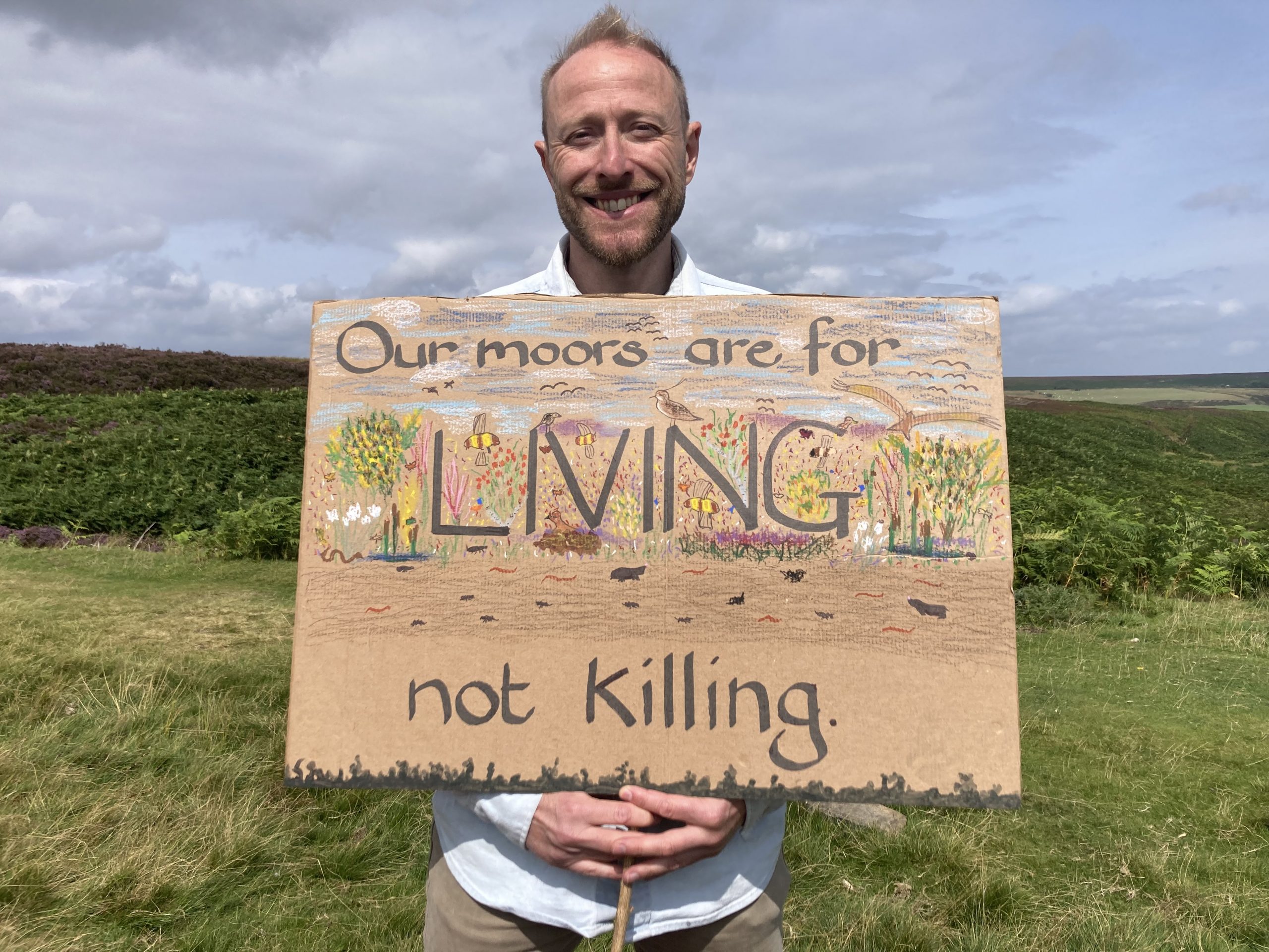 Cllr Peter Gilbert with sign saying "Moors are for Life, not Killing"