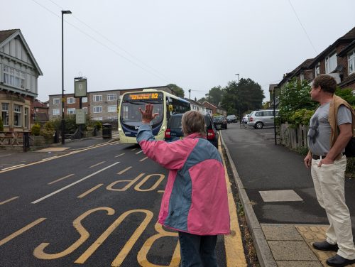 A bus passenger hails the new 82 Service at the Greystones.