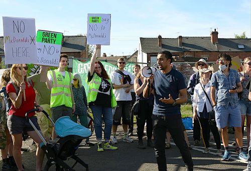 Cllr Maroof Raouf speaking at a demo with a megaphone