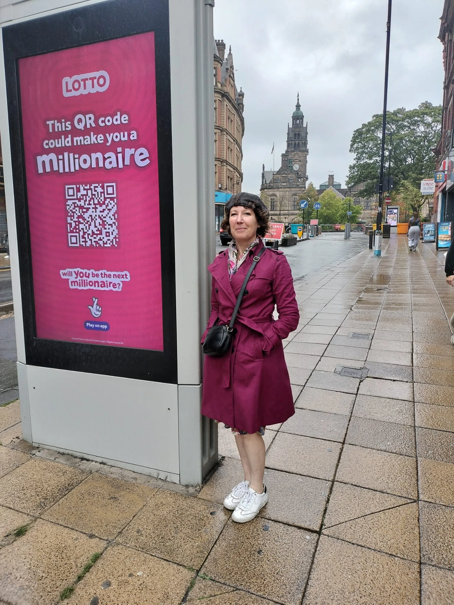 Cllr Ruth Mersereau next to a giant digital advertising board near Sheffield Town Hall