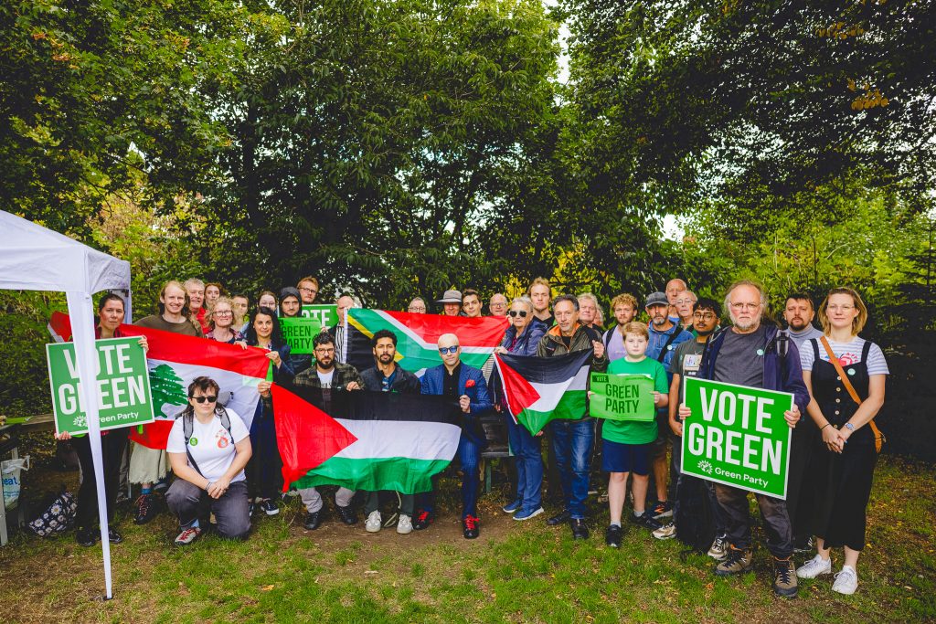 Green Party members in Walkley with flags from Palestine, Lebanon and South Africa and Vote Green signs. 